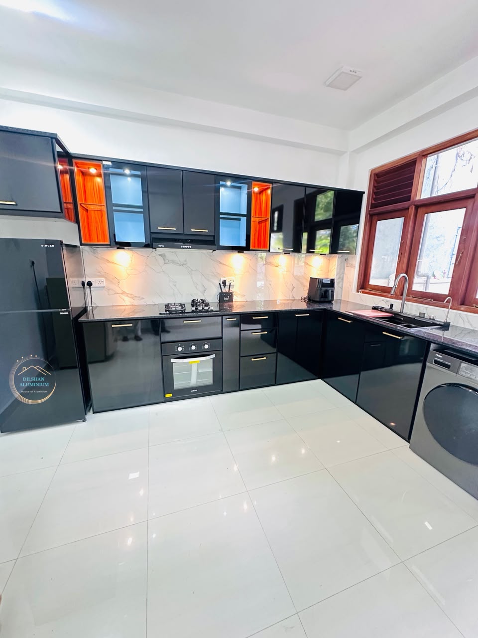 Black kitchen with gold handles and pull-out drawers